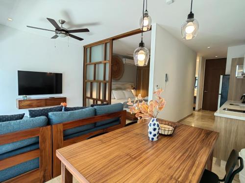 a living room with a blue couch and a table at IPANA Luxury Apartments by Vacaciones.Yeah in Playa del Carmen