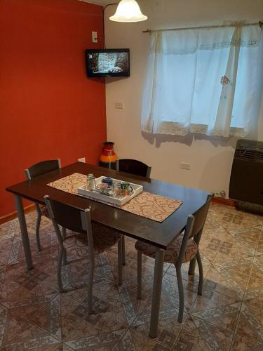 a dining room table and chairs in a room at Hospedaje Naim in Ushuaia