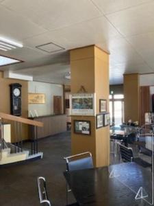 a room with a table and chairs and a clock at Echigo Yuzawa Hirokawa in Yuzawa