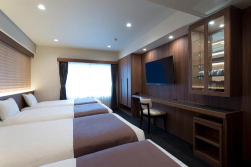 Ένα ή περισσότερα κρεβάτια σε δωμάτιο στο Kadoya Hotel