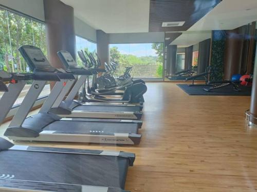 a gym with a row of treadmills in a room at The CLIO 2 residences, beside ioi city mall, opposite hospital Serdang, beside Uniteen and UPM, Putrajaya in Putrajaya