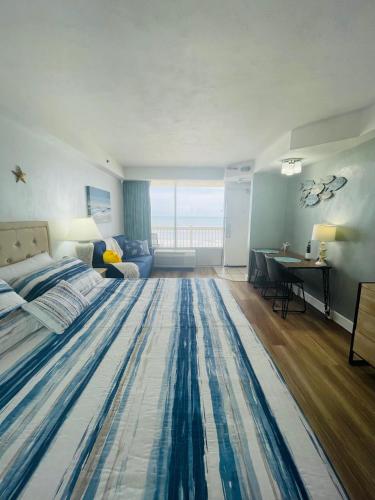 a bedroom with a large rug on the floor at Daytona Beach Resort Oceanfront CondoStudio in Daytona Beach