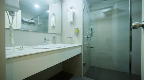 グルヴァイアールにあるHotel Guruvayur Darshanのバスルーム(シンク2台、シャワー付)