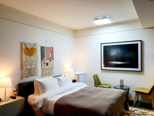 a hotel room with a bed and a flat screen tv at JS Boutique Hotel in Hwaseong