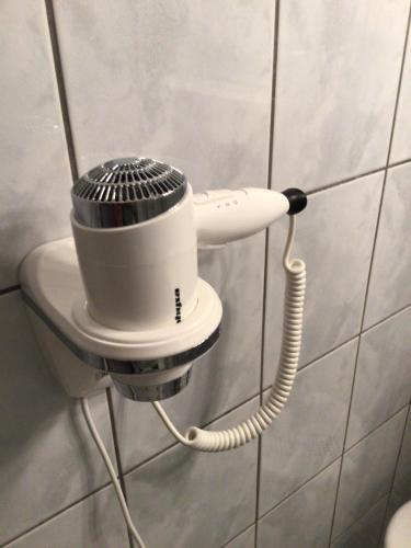 a hair dryer is attached to a wall at Pension Claudia in Vösendorf