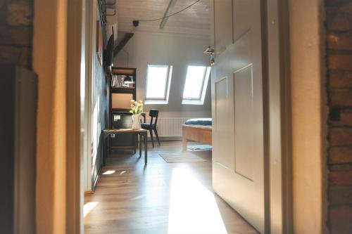 a hallway with a room with a table and a desk at CASA HINTZ Transilvania in Făgăraş