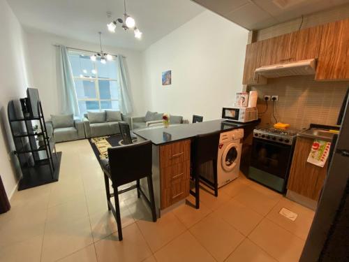 a kitchen with a sink and a counter top at Lovely 1-bedroom Apartment with free Parking on premises in Ajman 