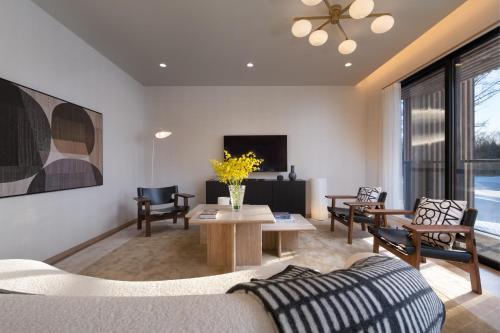 a living room with a couch and a table at Ginto Hirafu by H2 Life in Kutchan