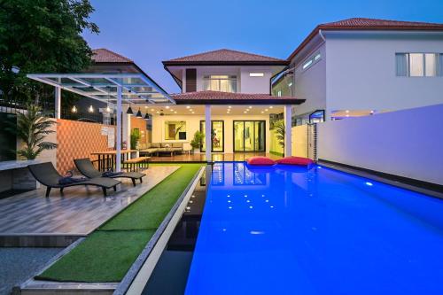 a swimming pool in the backyard of a house at 4BD Pool Villa Pattaya with Jacuzzi - Exquisite Pool Villa A in Pattaya South