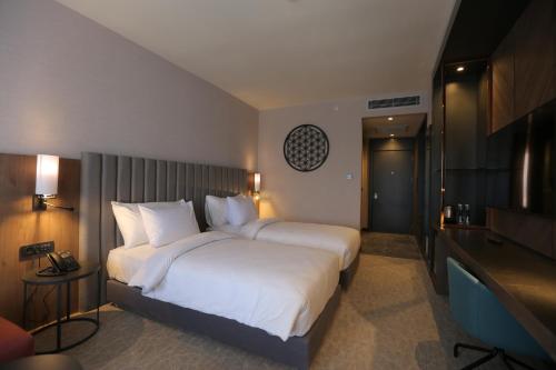 A bed or beds in a room at Crowne Plaza Ankara, an IHG Hotel