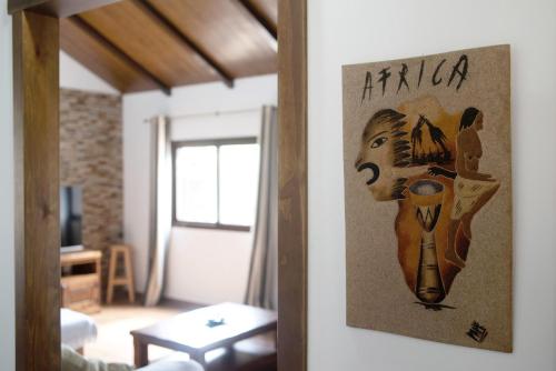 a living room with a painting of a woman at Villa Africa in La Muela