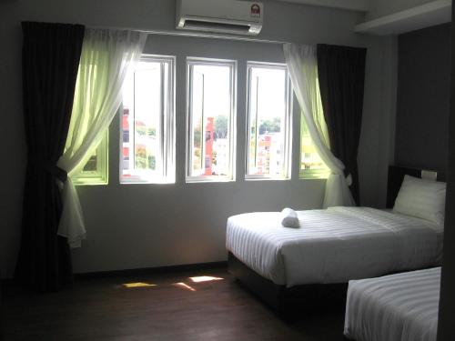 Postel nebo postele na pokoji v ubytování 707 Hotel (Cheng Ho ) Melaka