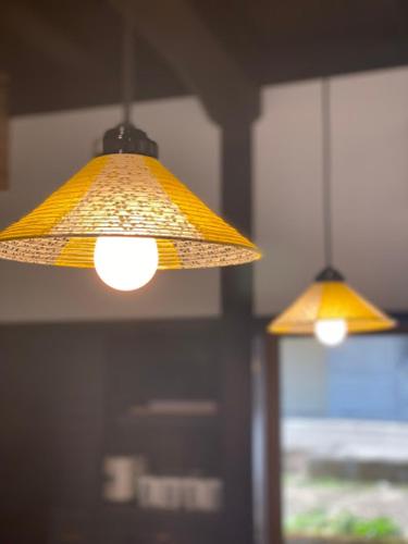 two lights hanging from the ceiling in a room at GOKAYAMA BASE in Nanto