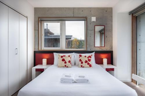 a bedroom with a large bed with two towels on it at Yuki Uchi by H2 Life in Niseko