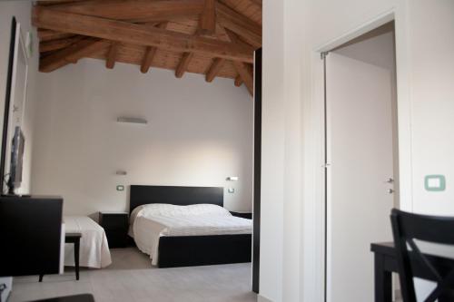 En eller flere senger på et rom på Le Stanze di Bacco