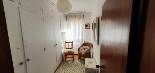a hallway with a room with two chairs and a window at La Pescal in Arriondas