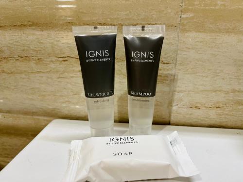 two bottles of cosmetics sitting on a white table at NEELGAGAN RESORT in Chaukori