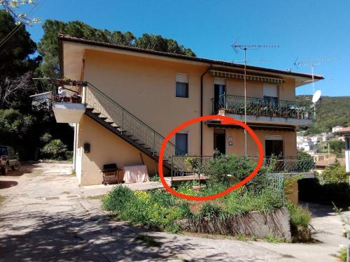 a house with a red circle in front of it at CASA VACANZE My Way in Cavo