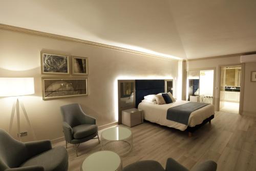 a hotel room with a bed and two chairs at Boutique Hotel B51 in Marbella
