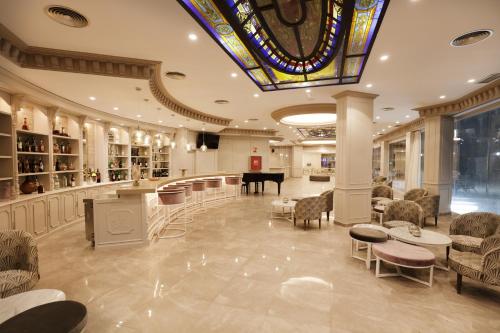a lobby with a grand piano and chairs and a table at Boutique Hotel B51 in Marbella