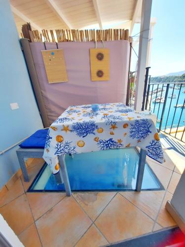 a table on the balcony of a ship at Monolocale Azzurro Procida in Procida