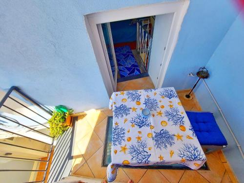 a view of a room with a bed on a balcony at Monolocale Azzurro Procida in Procida