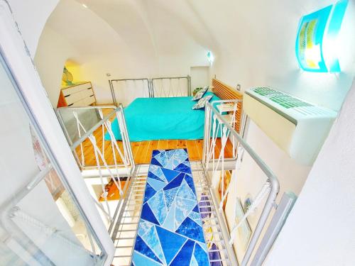 a staircase leading up to a room with a bed at Monolocale Azzurro Procida in Procida