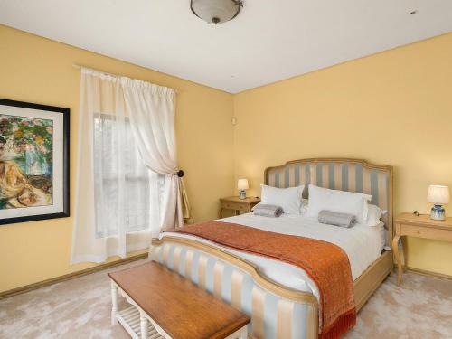 a bedroom with a large bed and a window at 295 on Ingwenya in Dullstroom