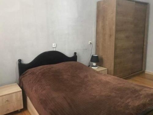 a bedroom with a large bed and two night stands at Sololaki Dadiani in Tbilisi City