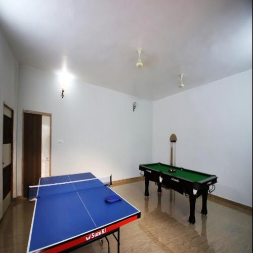 a ping pong table in an empty room with a ping pongetitive at Virat Resorts, Sariska Rajasthan in Bairāt