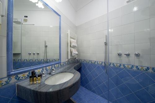 a bathroom with a sink and a mirror at Hotel Casa Albertina in Positano