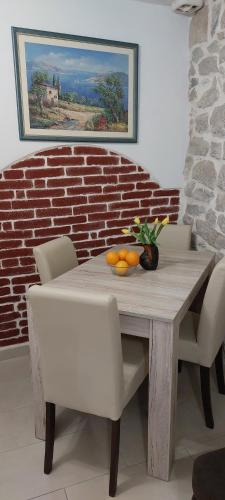 a dining room table with chairs and oranges on it at Antea in Split