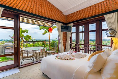 a bedroom with a large bed and a balcony at Angel Garden Villa in Hoi An