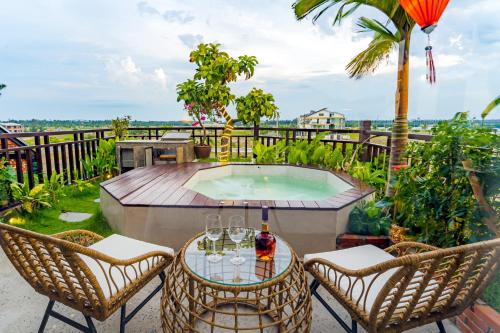 a patio with a table and chairs and a pool at Angel Garden Villa in Hoi An