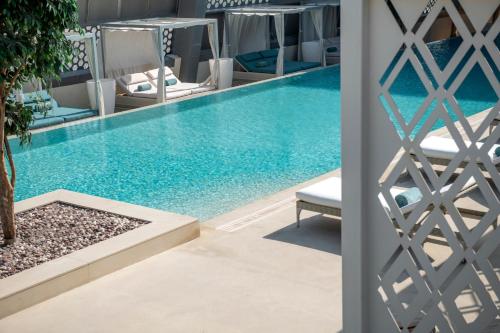 a swimming pool next to a villa at Steigenberger Hotel Doha in Doha
