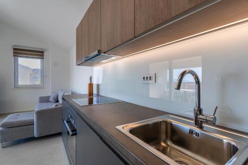 a kitchen with a sink and a counter top at Breakaway Apartment in Cres