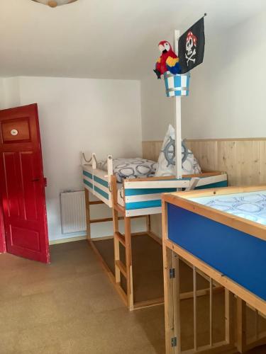 a bedroom with a bunk bed and a red door at Rosenhof in Görisried
