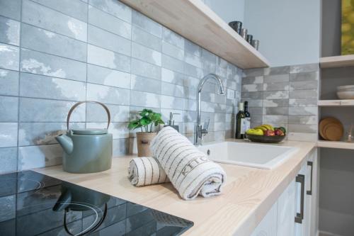 a kitchen with a sink and a counter with a towel at M&E house in Agios Nikolaos