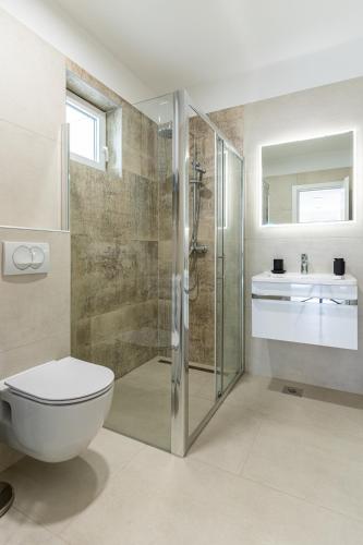 a bathroom with a shower and a toilet and a sink at Blue Sorbeto in Cres