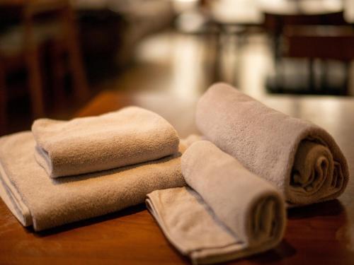a pile of towels sitting on top of a table at HOSTEL PAQ tokushima / Vacation STAY 35580 in Tokushima