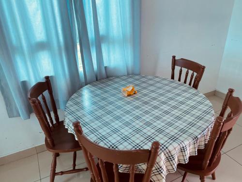 a table with chairs and a box of tissue on it at Spice Tunas 3B2B House in Bayan Lepas