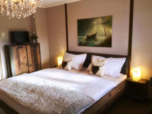 a bedroom with a bed with white sheets and pillows at Haus Louise in Reit im Winkl