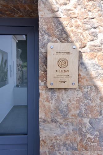 a box on a stone wall next to a door at Little House On The Prairie in Zefiría