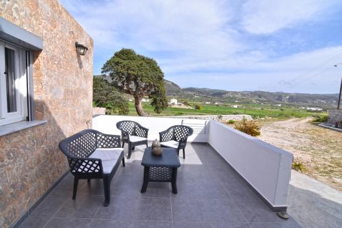 a patio with chairs and a table on a wall at Little House On The Prairie in Zefiría