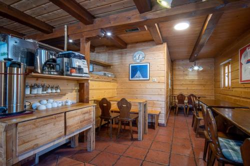 a restaurant with wooden walls and tables and chairs at Penzion Koucký in Bedřichov