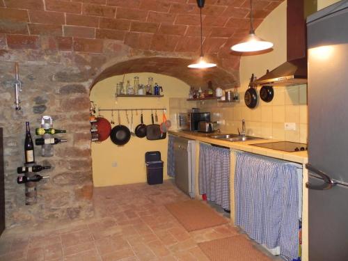 a kitchen with a stone wall and a counter top at BAIX EMPORDÀ. Increíble casa en pueblo medieval in Cruïlles