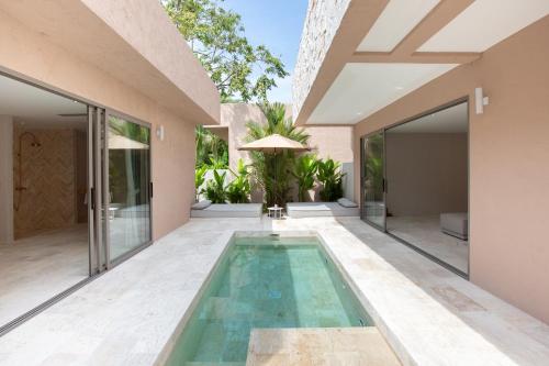 a swimming pool in the middle of a house at Cielo Boutique Hotel & Spa Samui in Bophut 