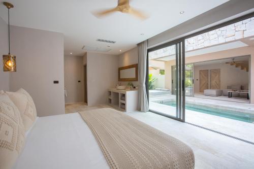 a bedroom with a bed and a swimming pool at Cielo Boutique Hotel & Spa Samui in Bophut 
