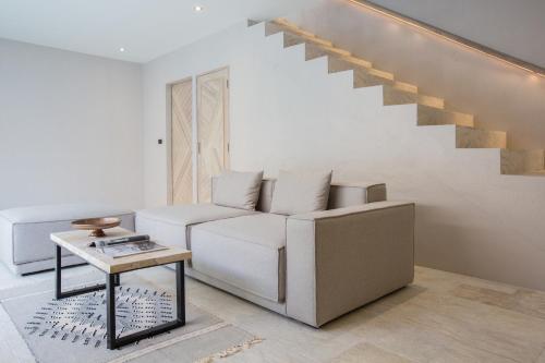 a living room with a white couch and a table at Cielo Boutique Hotel & Spa Samui in Bophut 
