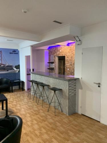 a kitchen with a bar with stools in a room at Place Polonia in Lisbon